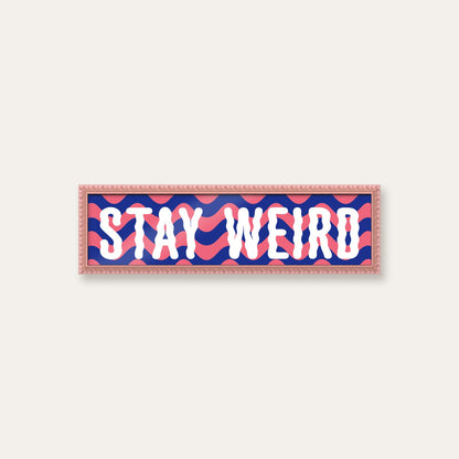 Stay Weird panoramic print in a pink bobbin frame