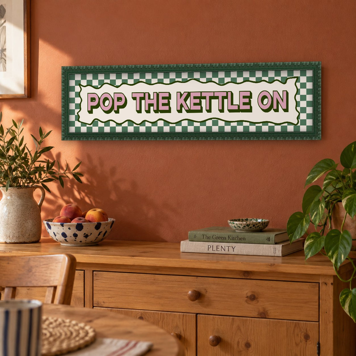 Pop The Kettle On panoramic print in a forest green bobbin frame in a room setting