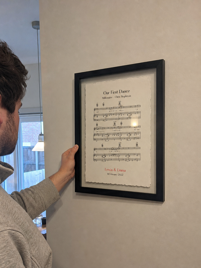 Customer hanging a personalised sheet music float mount print